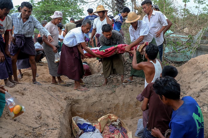 Bodies are buried after a school was destroyed by a junta bombing at Oe Htein Kwin village in Tabayin township in Sagaing, May 12, 2025.