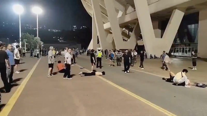Wounded people lie on the ground after a car plowed into a crowd at a sports center in Zhuhai, China, Nov. 11, 2024.
