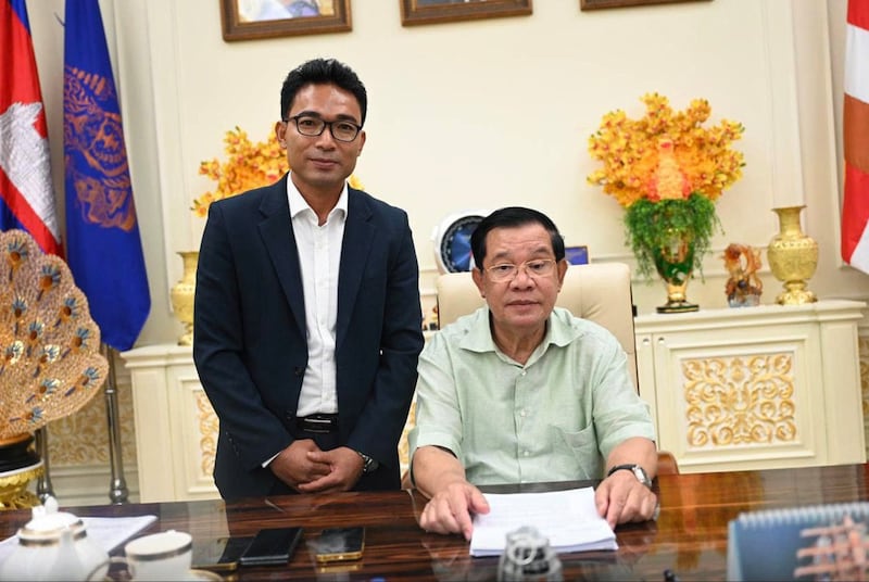 Former CNRP youth leader Yim Sinorn poses for a photo with then-Cambodian Prime Minister Hun Sen on April 21, 2023.